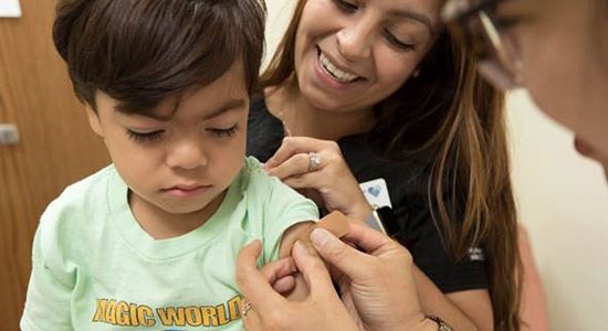 Medical Assisting involves a range of tasks. A medical assistant is putting a Band-Aid on a child after administering a vaccine on the child.