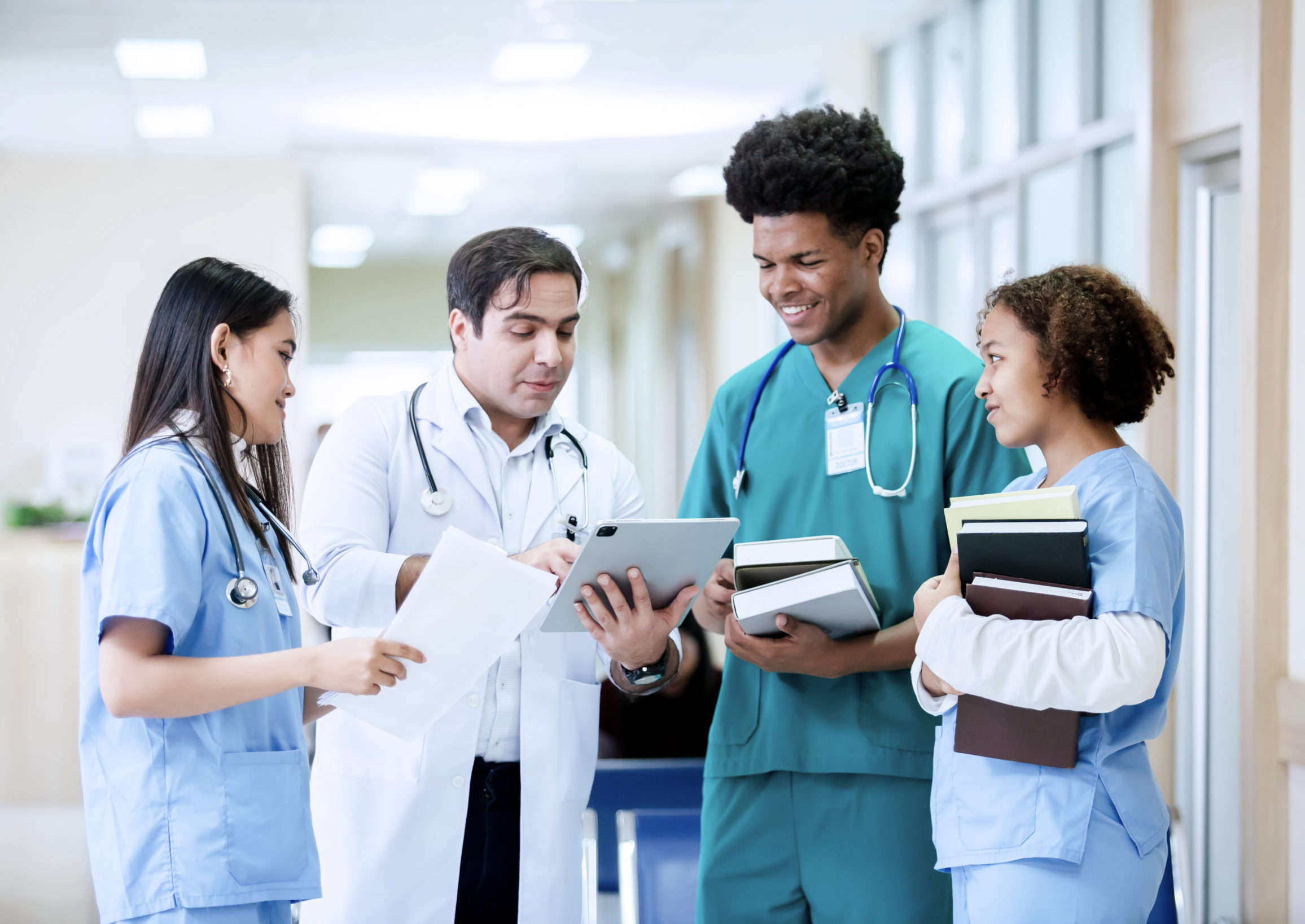 Teacher doctor man and group medical student standing looking work in tablet. education and learning medical concept. vocational nurse students study from professional.